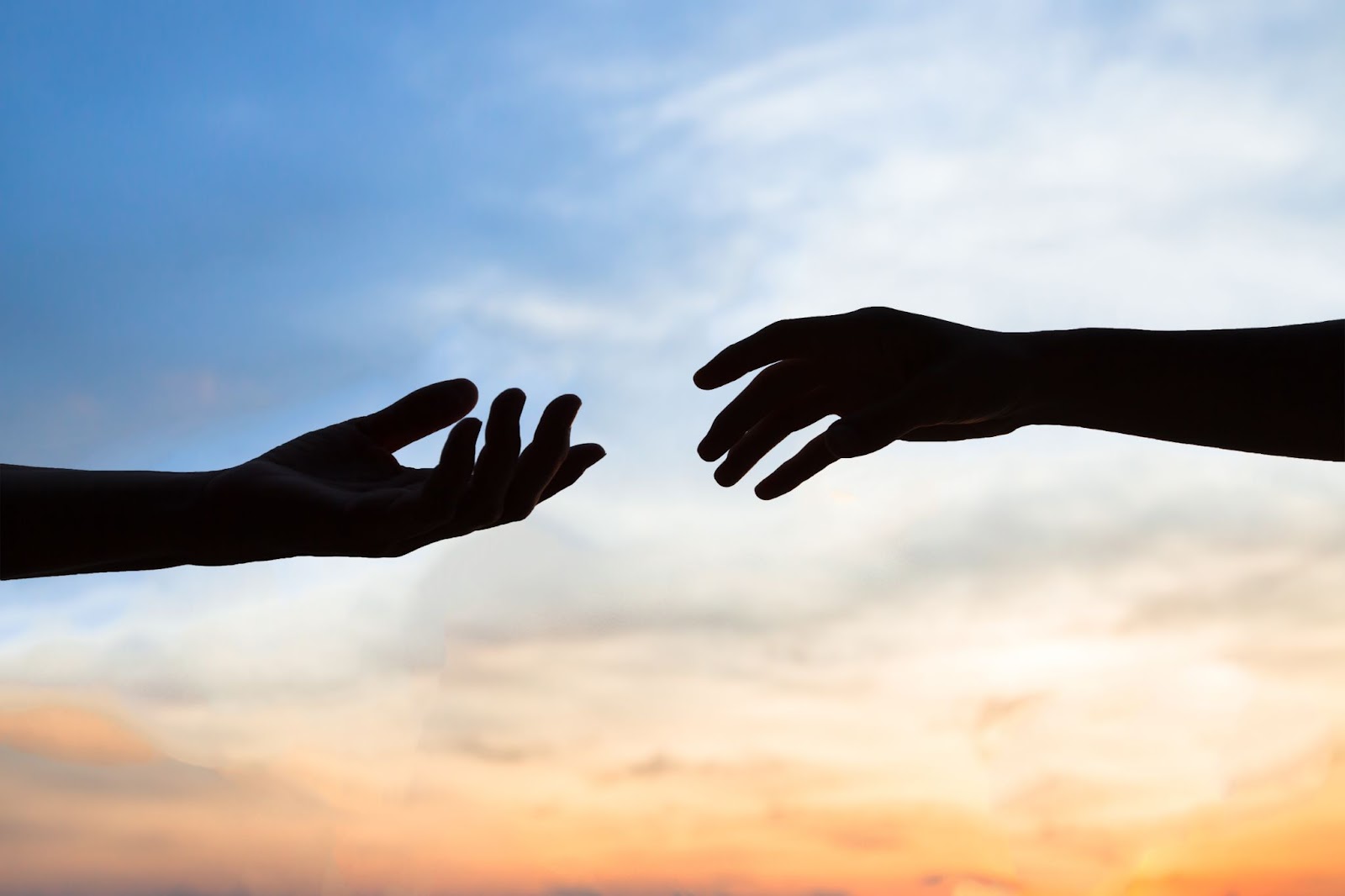 Hands reaching out to help each other