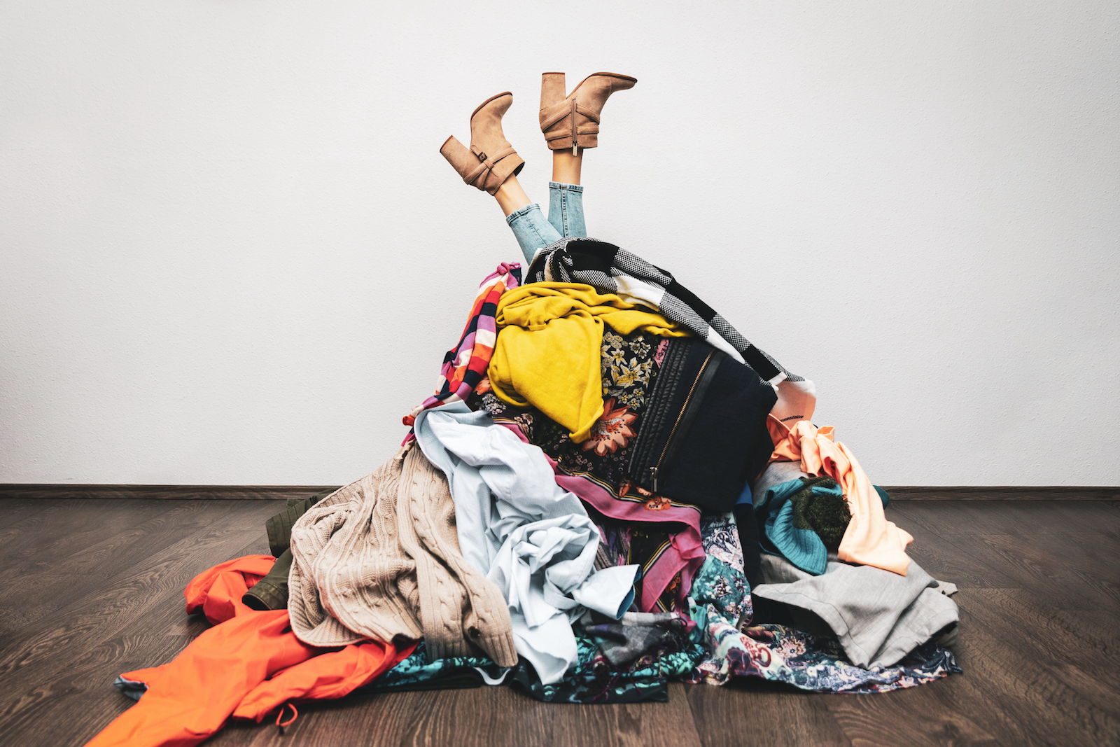 A woman buried in a pile of clothes for the splash tears eye drops blog