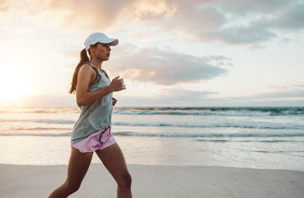 A woman jogging on the beach for the splash tears blog the best over-the-counter eye drops