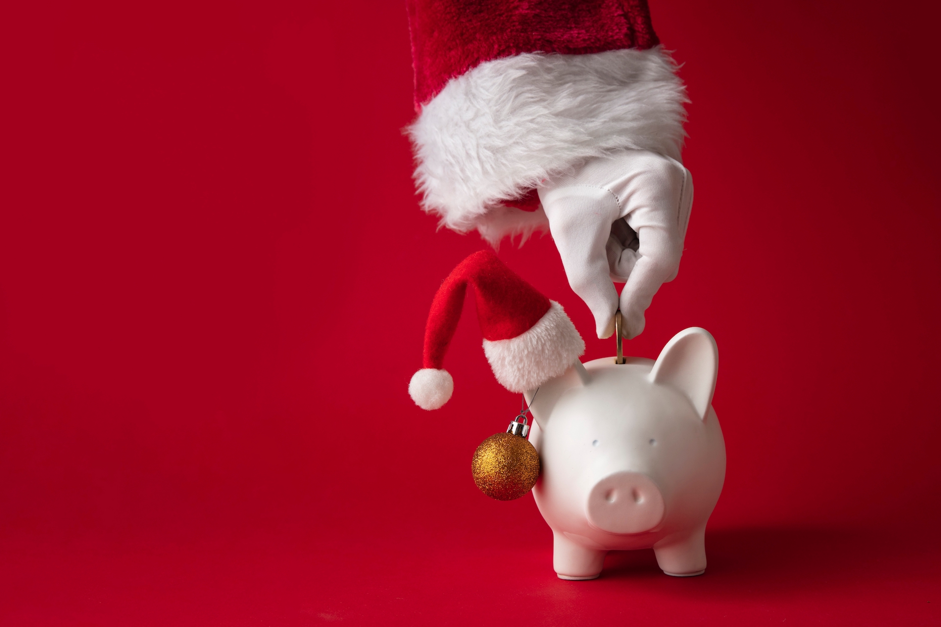 Santa putting money into a piggy bank with a christmas hat for the Splash Tears Dry Eye Drops blog